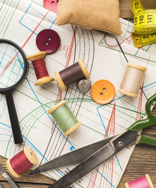top-view-thread-with-magnifying-glass-scissors